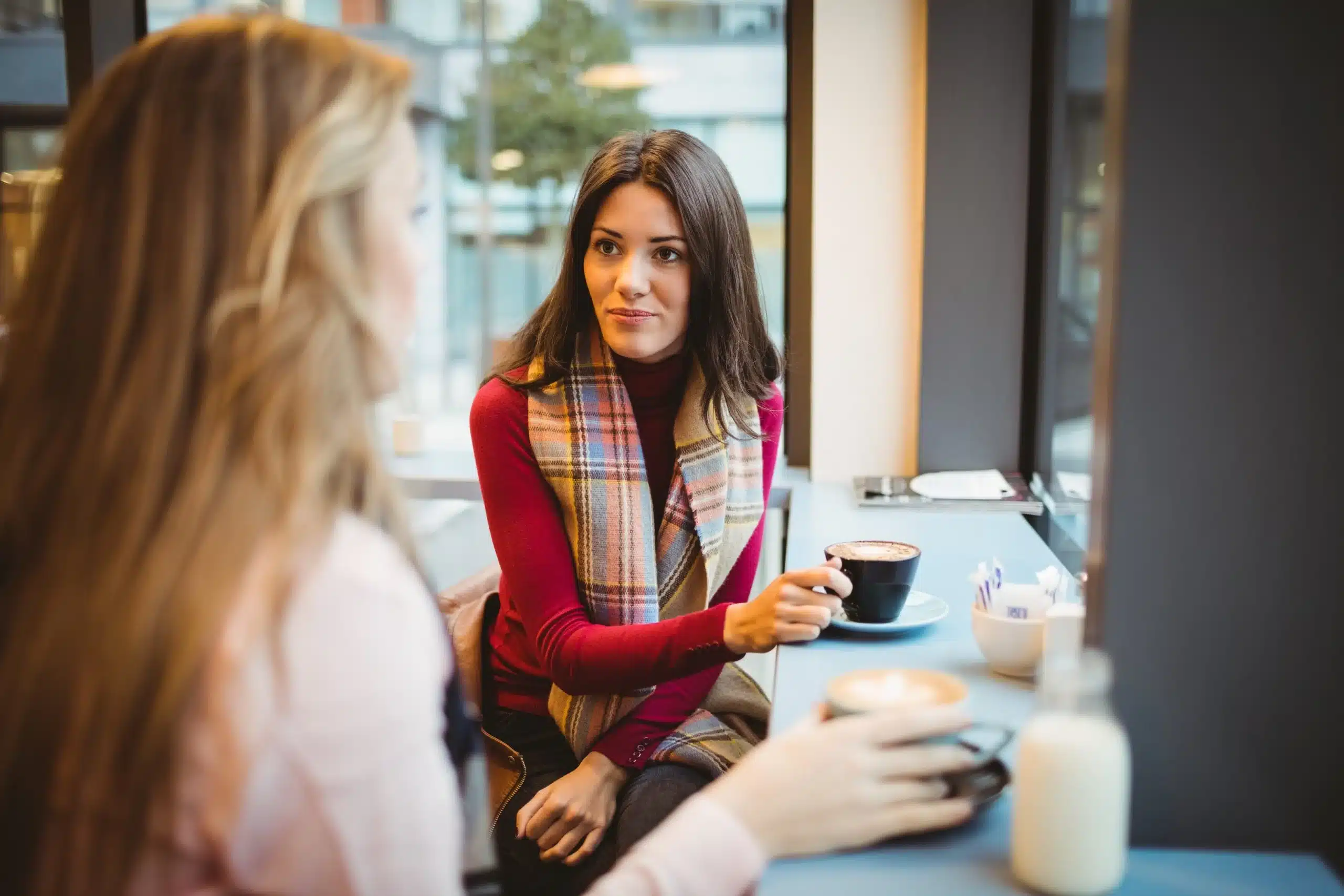 Two women talking over coffee